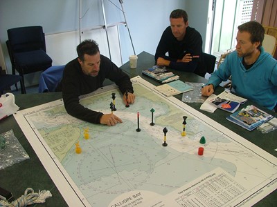 Men working with boat charts